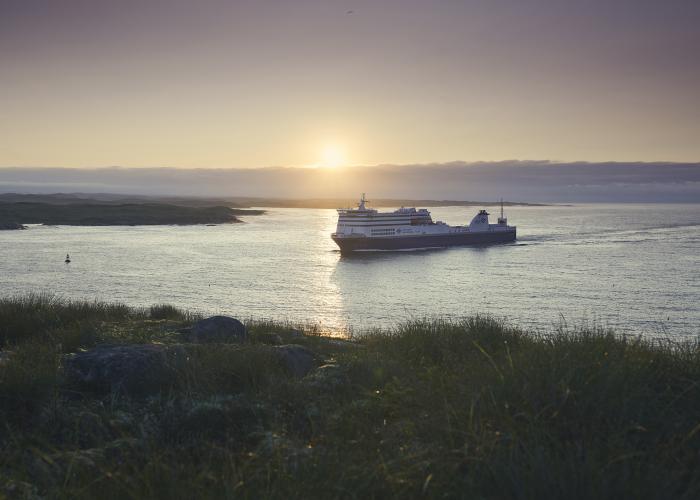 ferry sailing at sunset