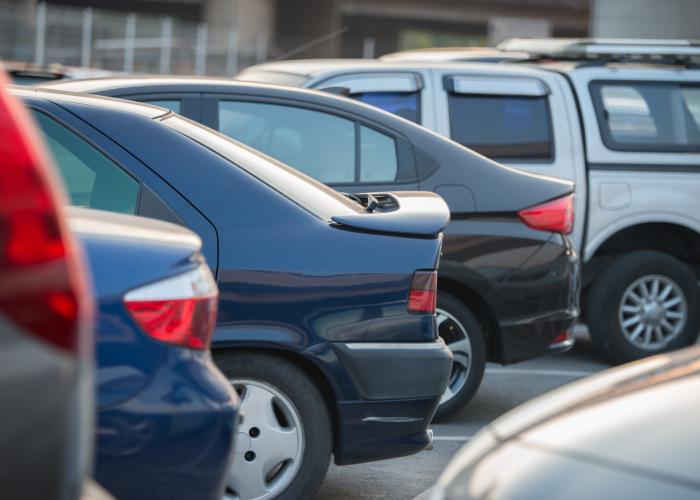 Several vehicles parked in parking lot.