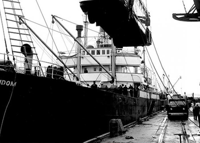 Image: black and white, loading bus onto the SS Random