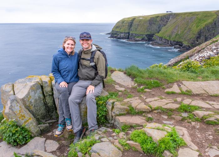 A couple sitting by the coast of Newfoundland