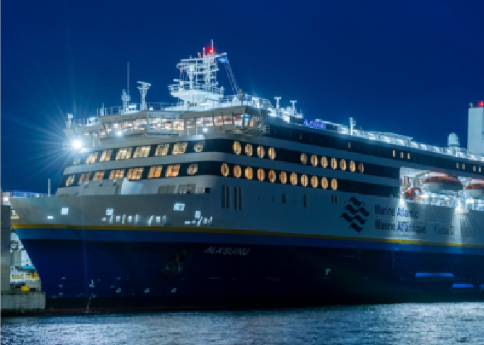 Vessel docked at night with lights shining 