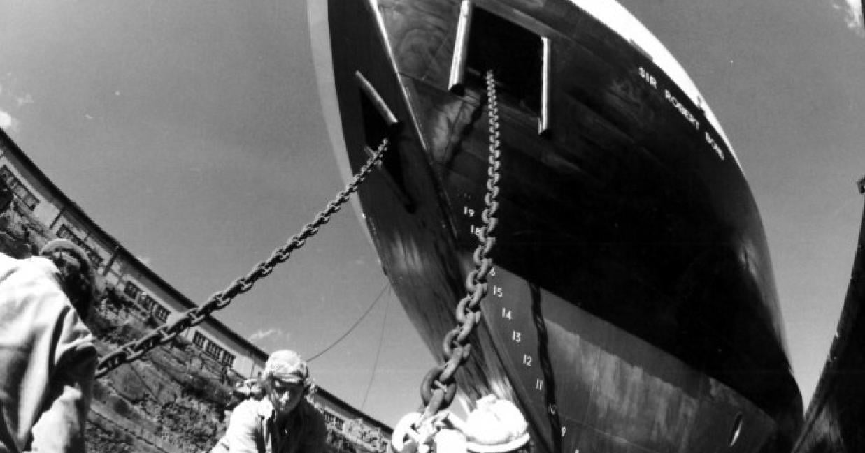 Men helping dock the bond